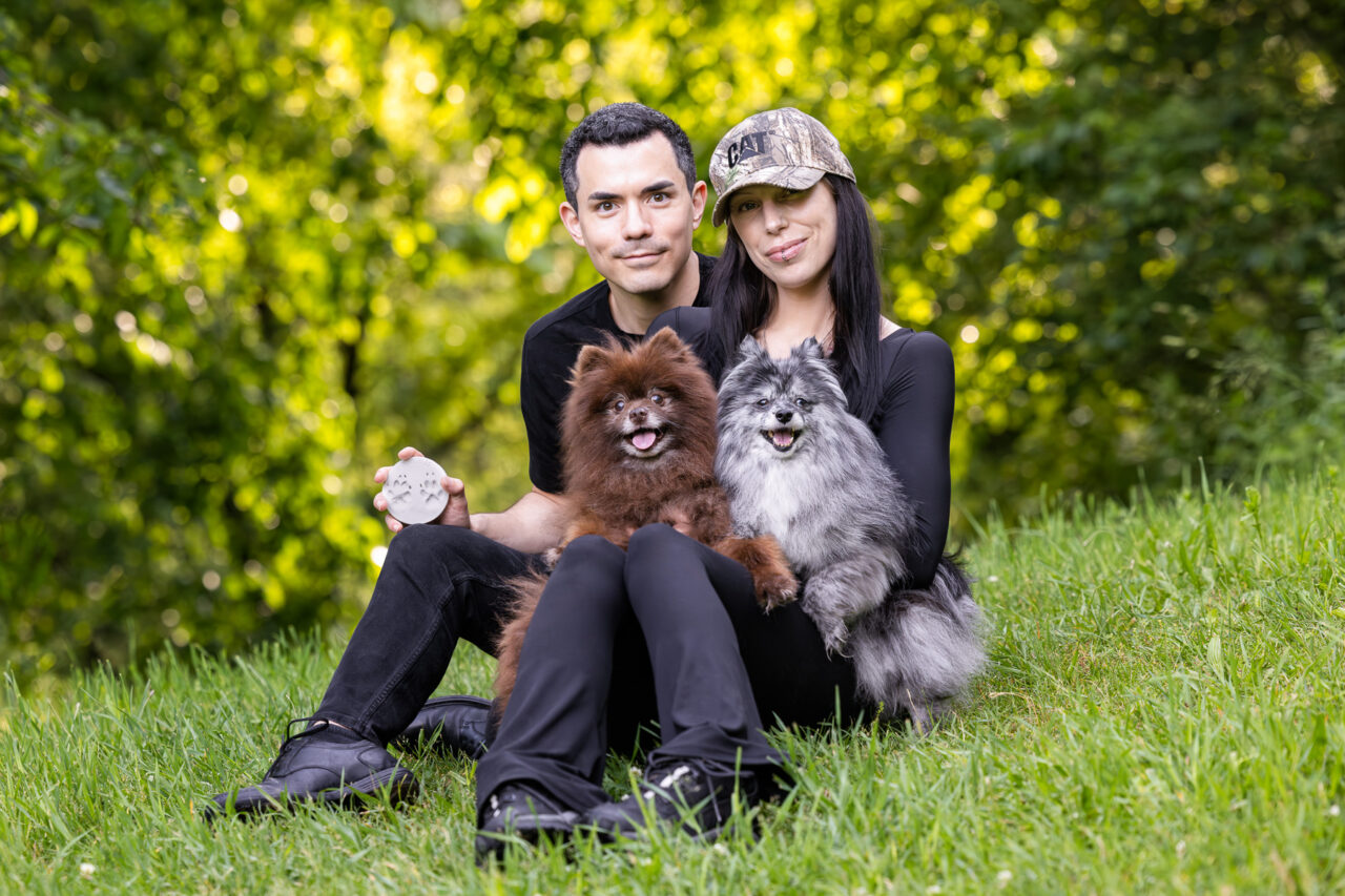 A young man and woman with their two Pomeranians at Prairie Wolf Park in Caledonia, MI.